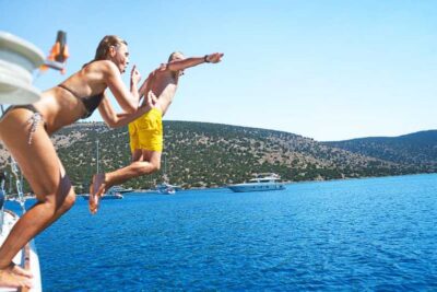 Boat Party to the Beach with Swimming Stops, DJ and Open Bar
